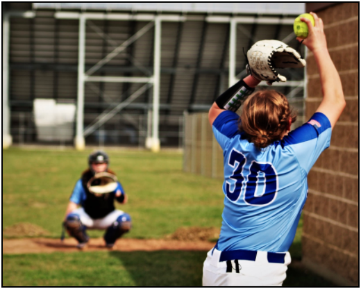 Avery Sexton 24 and Melaina Roach 24 practice pitching and catching. All players arrived half an hour before the game to warm up. Other players practiced batting and positioning.