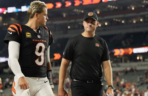 Burrow walks off the field with Taylor. They were both upset with the outcome of Monday’s game.