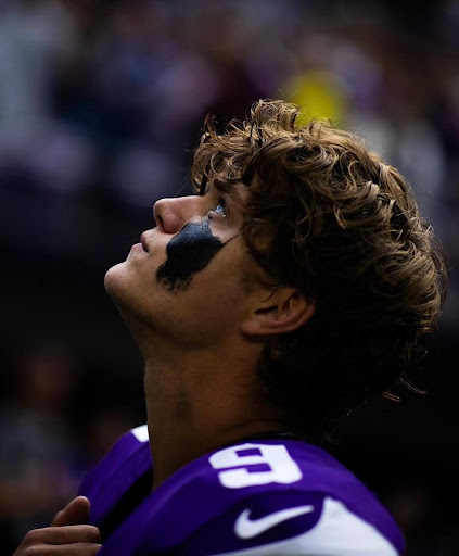 Minnesota Vikings Quarterback JJ McCarthy looks up to the sky for the national anthem. McCarthy currently suffers a tear in his right meniscus and is scheduled to miss the 2024 season. Photo Courtesy: Instagram - @vikingsphotog 
