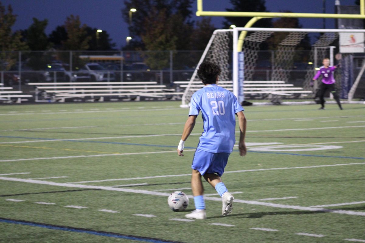 Miguel Cardoso Da Silva '28 is dribbling down the turf to look for a open teammate.