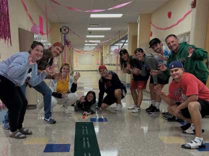   Dressed to impress, students and staff pose in the hallway while dressed as Adam Sandler. This day kicked off homecoming spirit week for the bears. 
