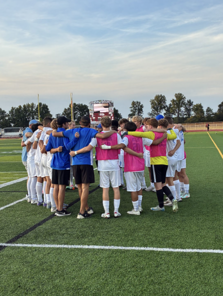 The Berlin Boys Soccer Team hugs in a huddle. These boys played Big Walnut and brought the team another victory.