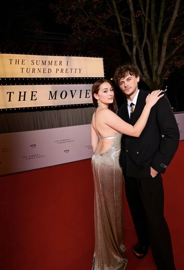 “The Summer I Turned Pretty” stars Lola Tung and Chris Briney pose in front of the movie announcement. Many fans speculated whether their characters would end up together at the end of the show. 
