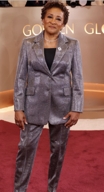  American stand-up comedian and actress, Wanda Skyes, poses on the Golden Globes Red Carpet while she wears a “BE GOOD” pin. This pin worn by various celebrities was worn in support of Renne Good and against ICE initiatives. 