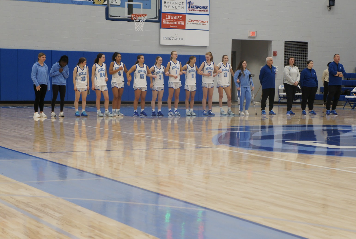 The girls basketball team lines up before they face off against New Albany. “This is always the most nerve wreaking part of the game. We all just finished warm ups and are ready to start the game” said Ella Craig ‘29.
