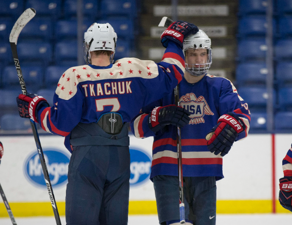Brady Tkachuk pats a teammate on his helmet during a game in February 2017, at USA Hockey Arena in Plymouth, Michigan.  Brady Tkachuk had five points in the 2026 Winter Olympics, where he won gold with Team USA. (Photo Credit: USNTDP)